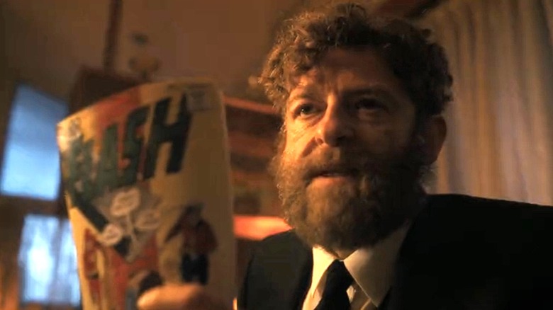 Rabbi Uris holding a Flash comic in It: Welcome to Derry