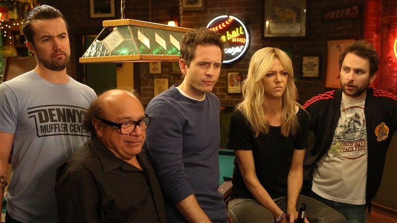 Mac, Dee, Dennis, Frank, and Charlie looking skeptical in 