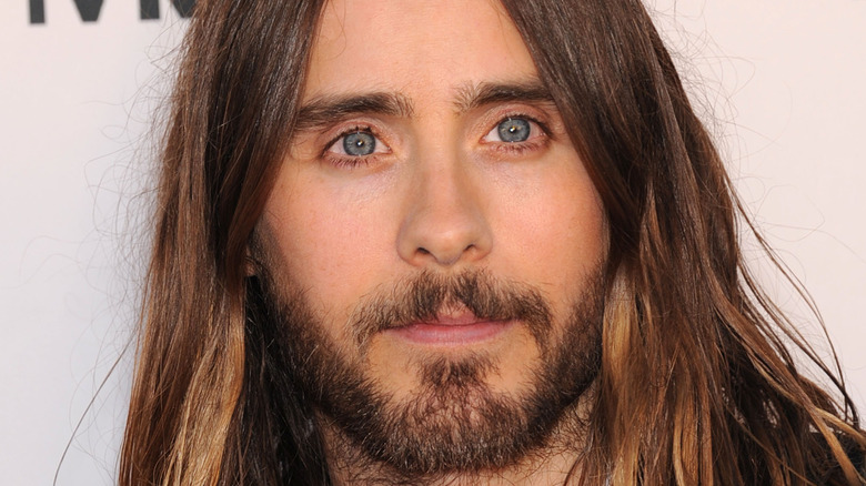 Jared Leto wears a neutral expresion