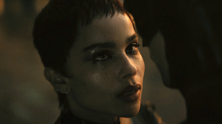 Selina Kyle staring at Bruce Wayne