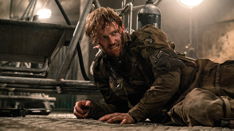 A wounded Corporal Ford crawls on the floor in 
