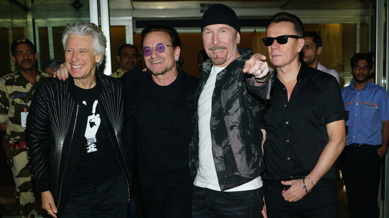 U2 smiling together at public event
