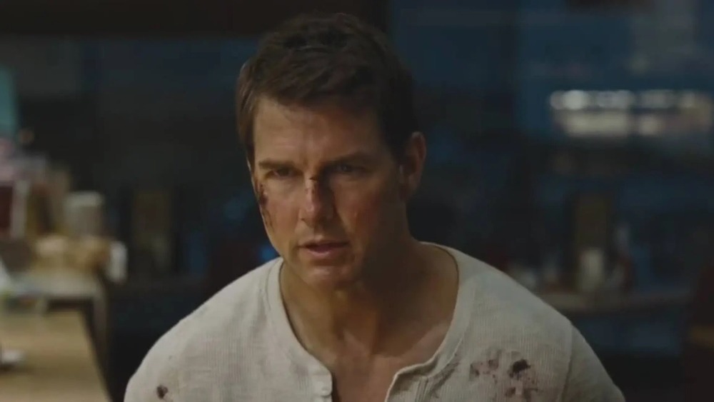 Tom Cruise wears a bloody shirt in Jack Reacher