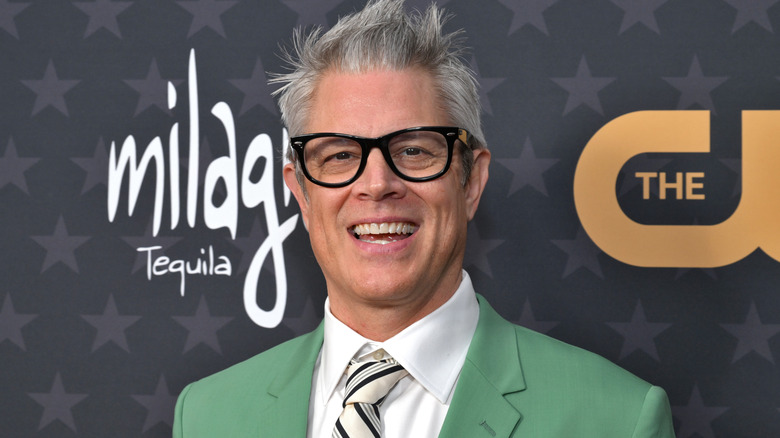 Johnny Knoxville wearing a green suit