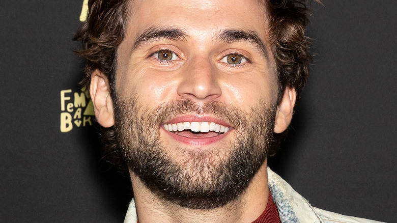 Jake Borelli smiling wide