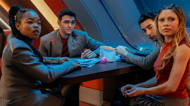 SAM, Darem, Ocam, and Genesis sitting at a table looking surprised in Starfleet Academy (2026)