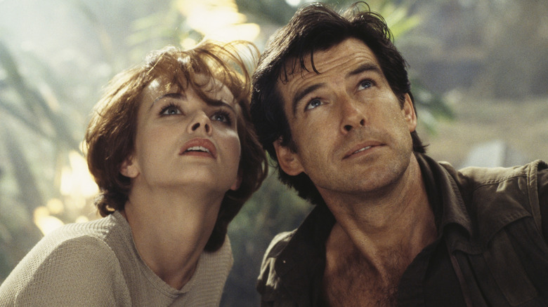 James Bond and Natalya in jungle looking up in 