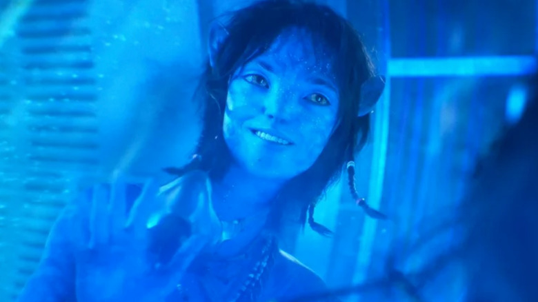 Kiri smiling and looking through glass