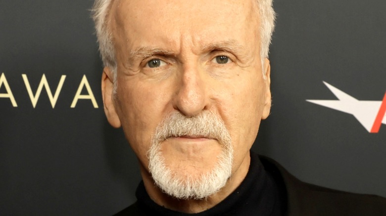 James Cameron posing for pictures