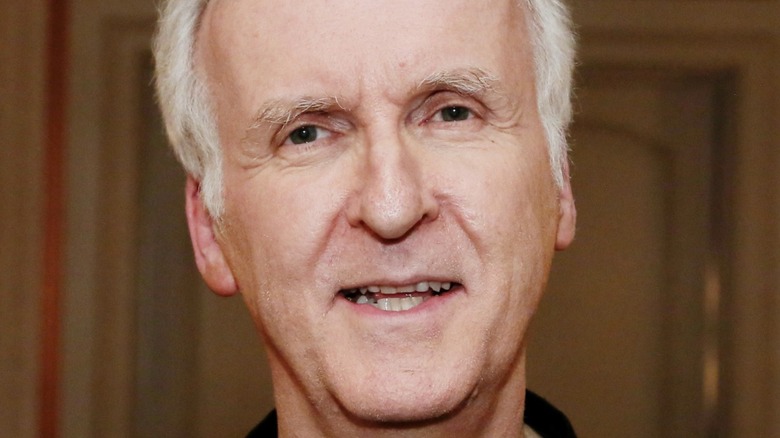 James Cameron posing for pictures