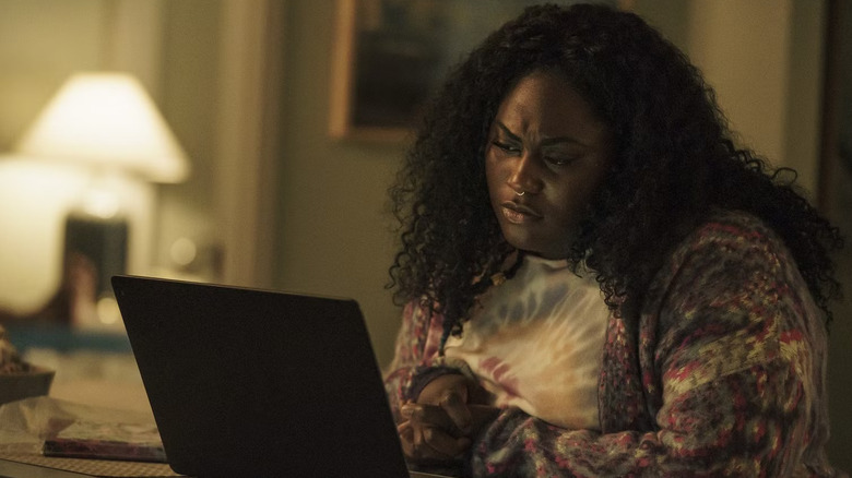 Naturally talented special agent Leota Adebayo scrolling on her laptop
