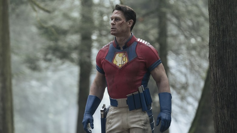 Peacemaker walking through the woods while dealing with his father's hatred and the Butterfly invasion