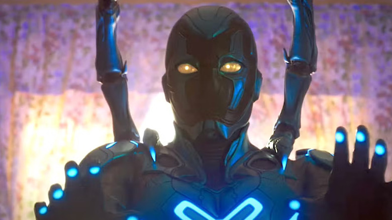 Jaime Reyes wearing the Blue Beetle exoskeleton and holding up his hands