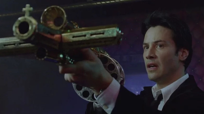 Constantine holding a mystical weapon