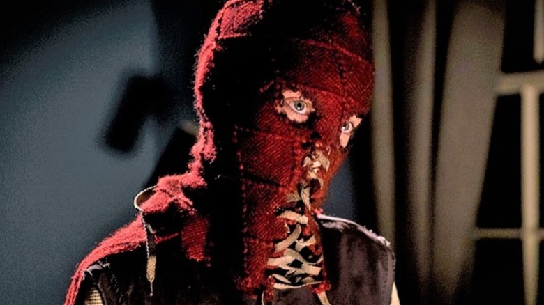 Brandon wearing his laced-up mask in Brightburn