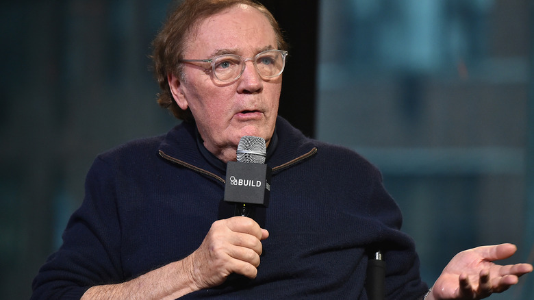 James Patterson holding microphone