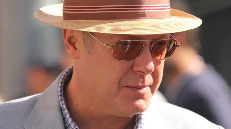 James Spader in a fedora looking down