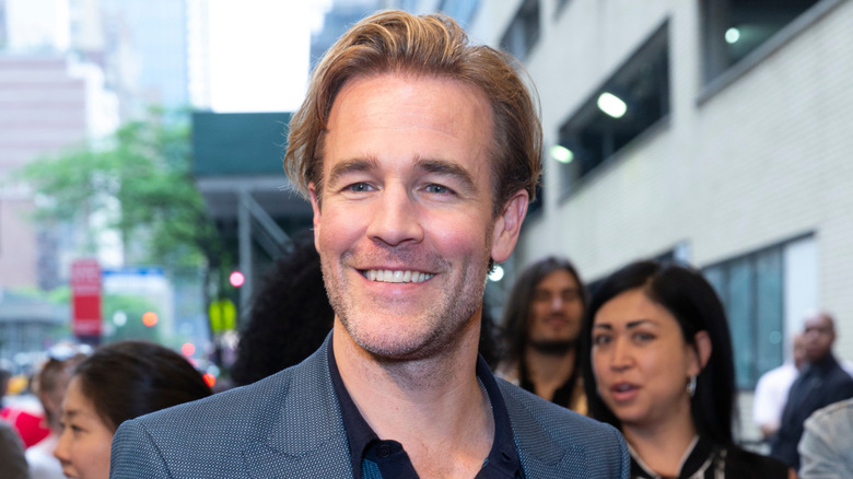 James Van Der Beek smiling in a green jacket