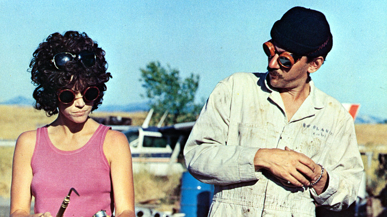 Jane Fonda repairs a car