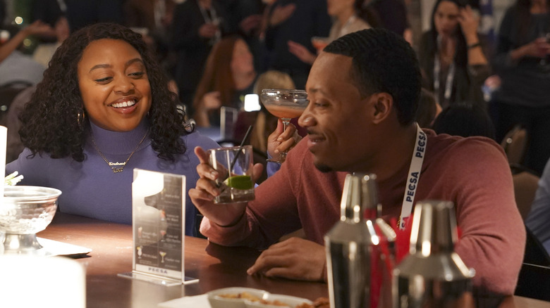 Janine and Gregory laughing at bar