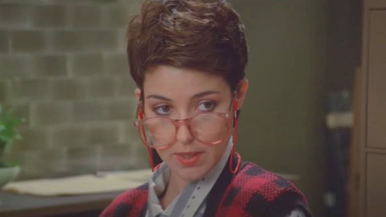 Janine talking as she looks over the tops of her glasses