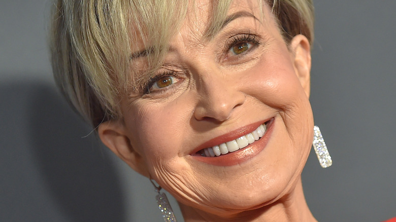 Annie Potts smiling on red carpet