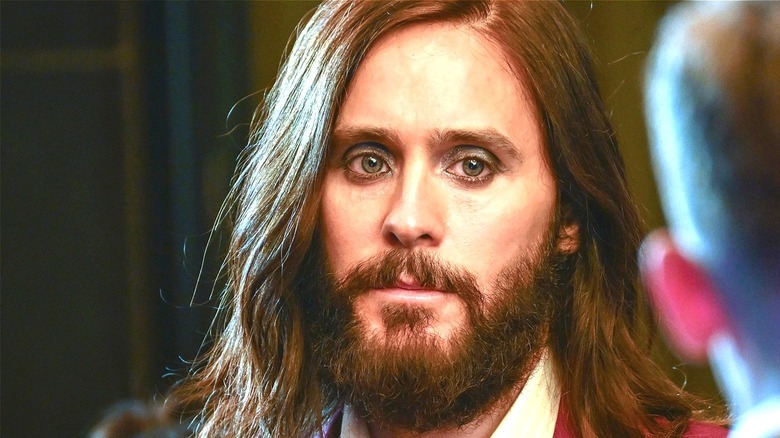 Jared Leto wears a red jacket