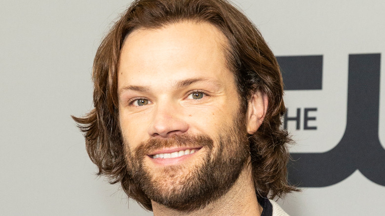 Jared Padalecki smiles at a CW event