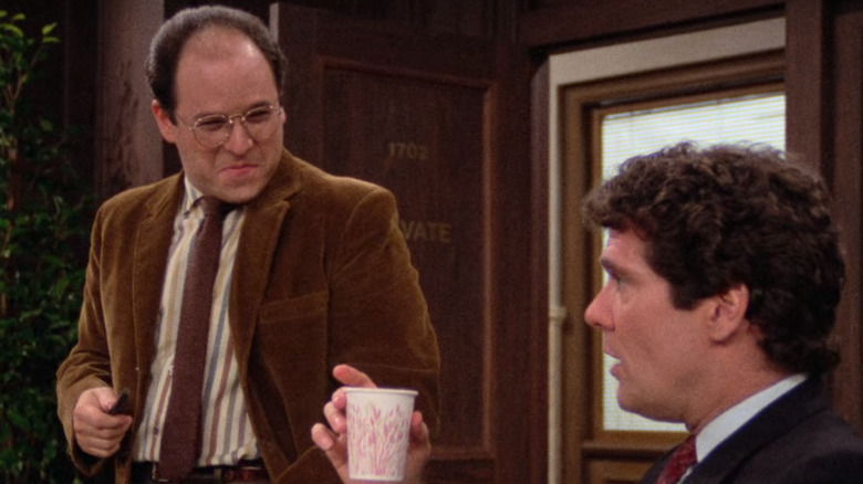 George standing at conference table