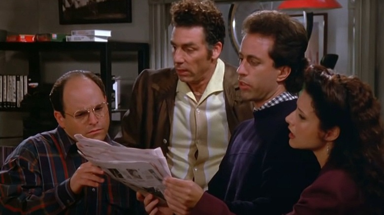 Jason Alexander, Michael Richards, Jerry Seinfeld and Julia Louis-Dreyfus reading newspaper together in Seinfeld