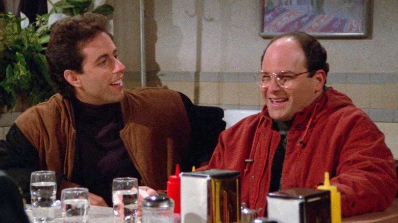 Jerry Seinfeld and Jason Alexander as George Costanza laughing at a restaurant