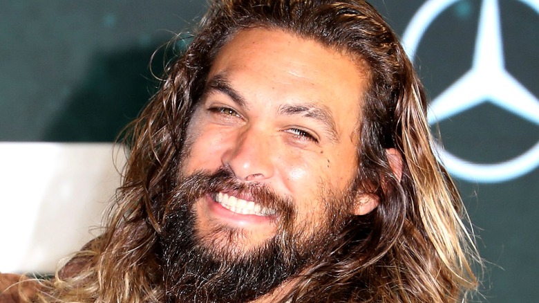 Jason Momoa smiling mercedes benz logo