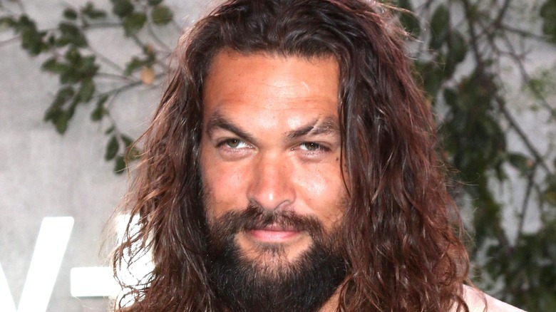 Jason Momoa smiles at event 