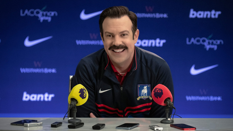 Ted Lasso smiling at press conference