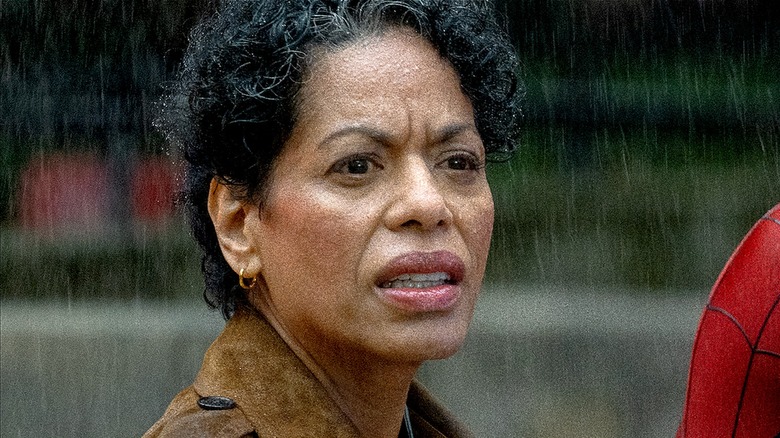 Detective Jean DeWolff squinting in the rain