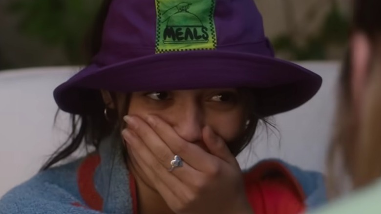 Vada Cavell wearing a purple hat and covering her face with her hand in The Fallout