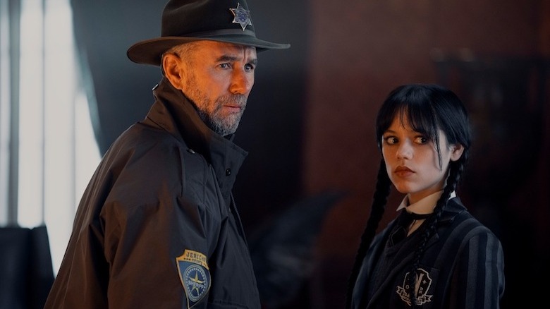 Wednesday and sheriff looking on