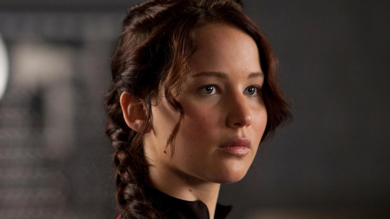 Katniss standing and looking ahead