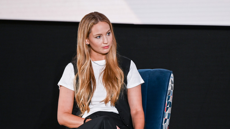 Jennifer Lawrence seated and listening