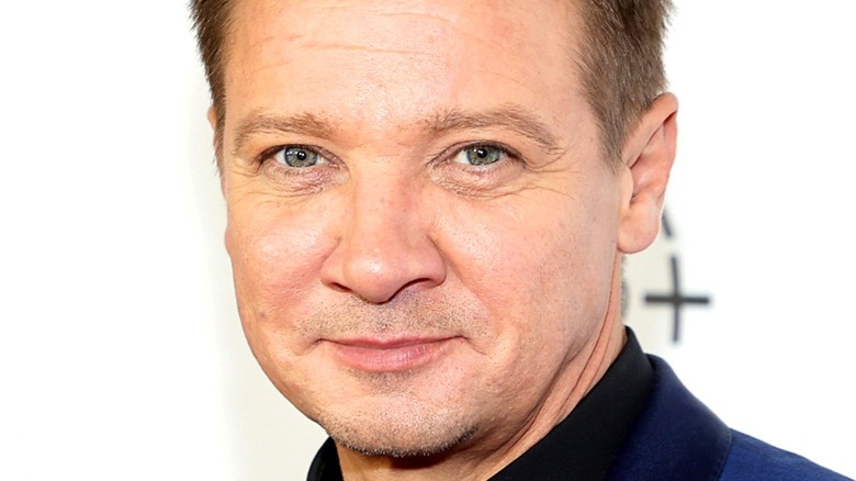 Jeremy Renner smiling into camera