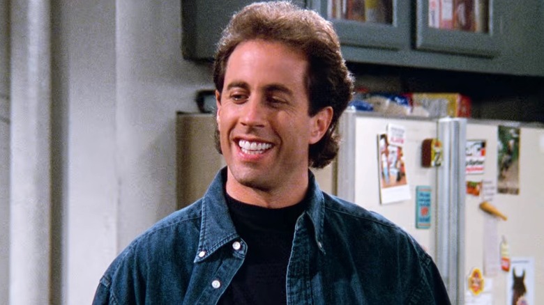 Jerry Seinfeld smiling in apartment