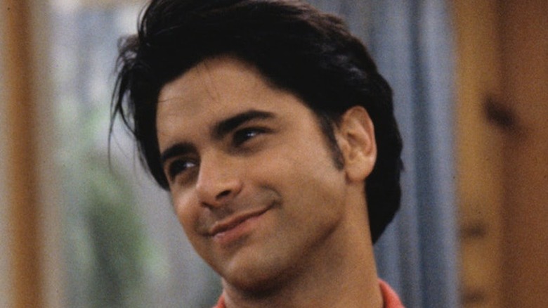 Uncle Jesse tilts head smiling