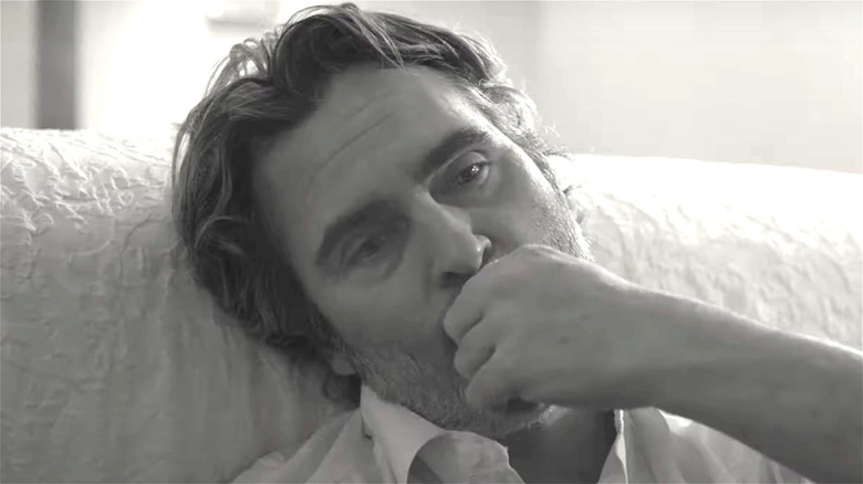 Joaquin Phoenix sitting on a couch