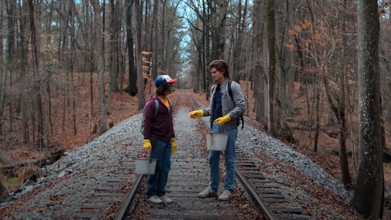 Dustin and Steve on train tracks in Stranger Things