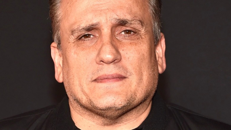 Joe Russo wears a neutral expression