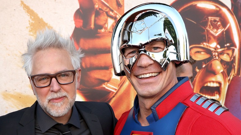 James Gunn, John Cena hugging and smiling at movie premiere