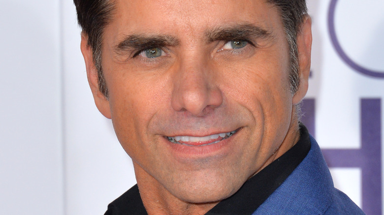 John Stamos smiling at event 