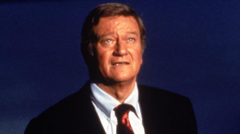 John Wayne talks on stage during his NBC special "Swing Out, Sweet Land"