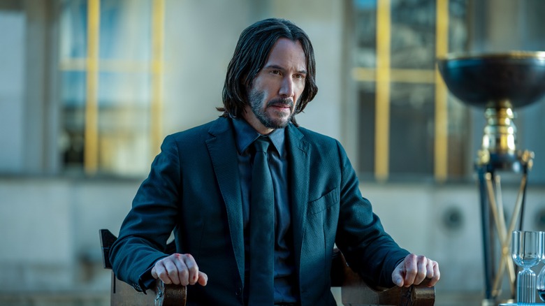 John Wick sits in a chair