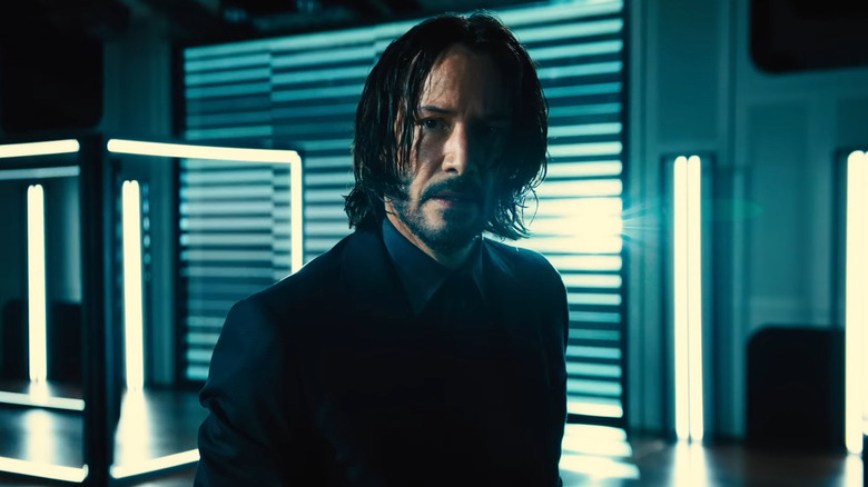 John Wick in neon-lit room